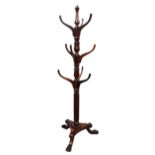 A c1850 mahogany hat stand, turned central column with nine outswept supports for hats,