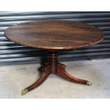 A 19th century walnut loo table raised on baluster and knopped column,