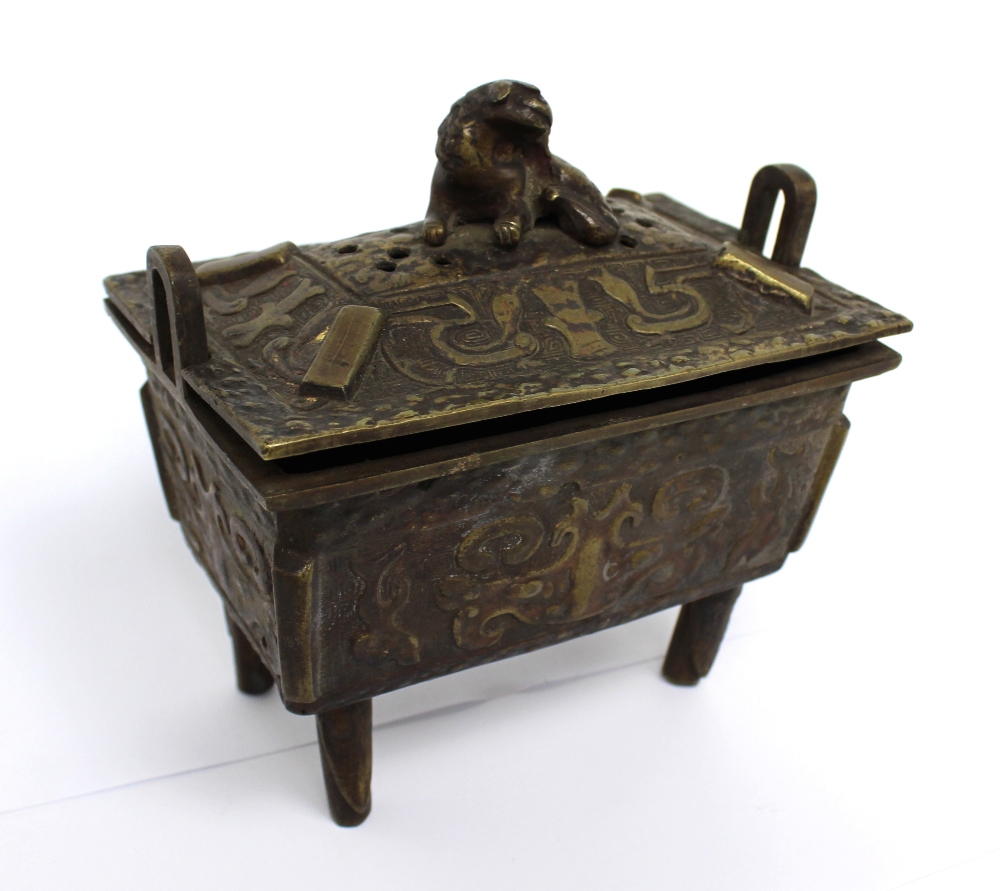 A 19th century Oriental bronze censer with Dog of Fo finial to pierced top,