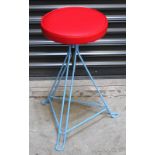 A retro-style height-adjustable stool with blue Eiffel base and circular red seat, 56cm.