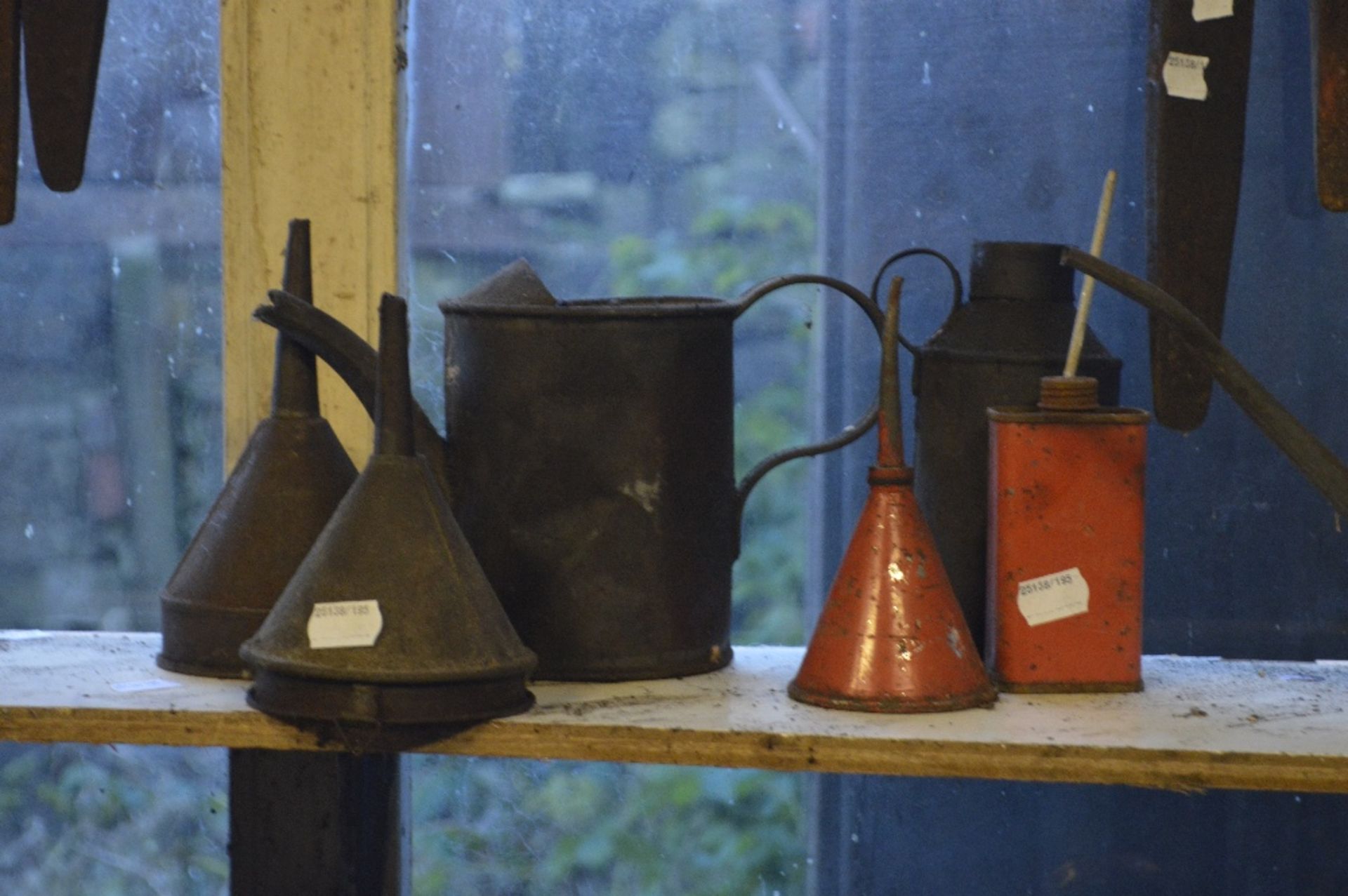 Four oil cans and three funnels (7).