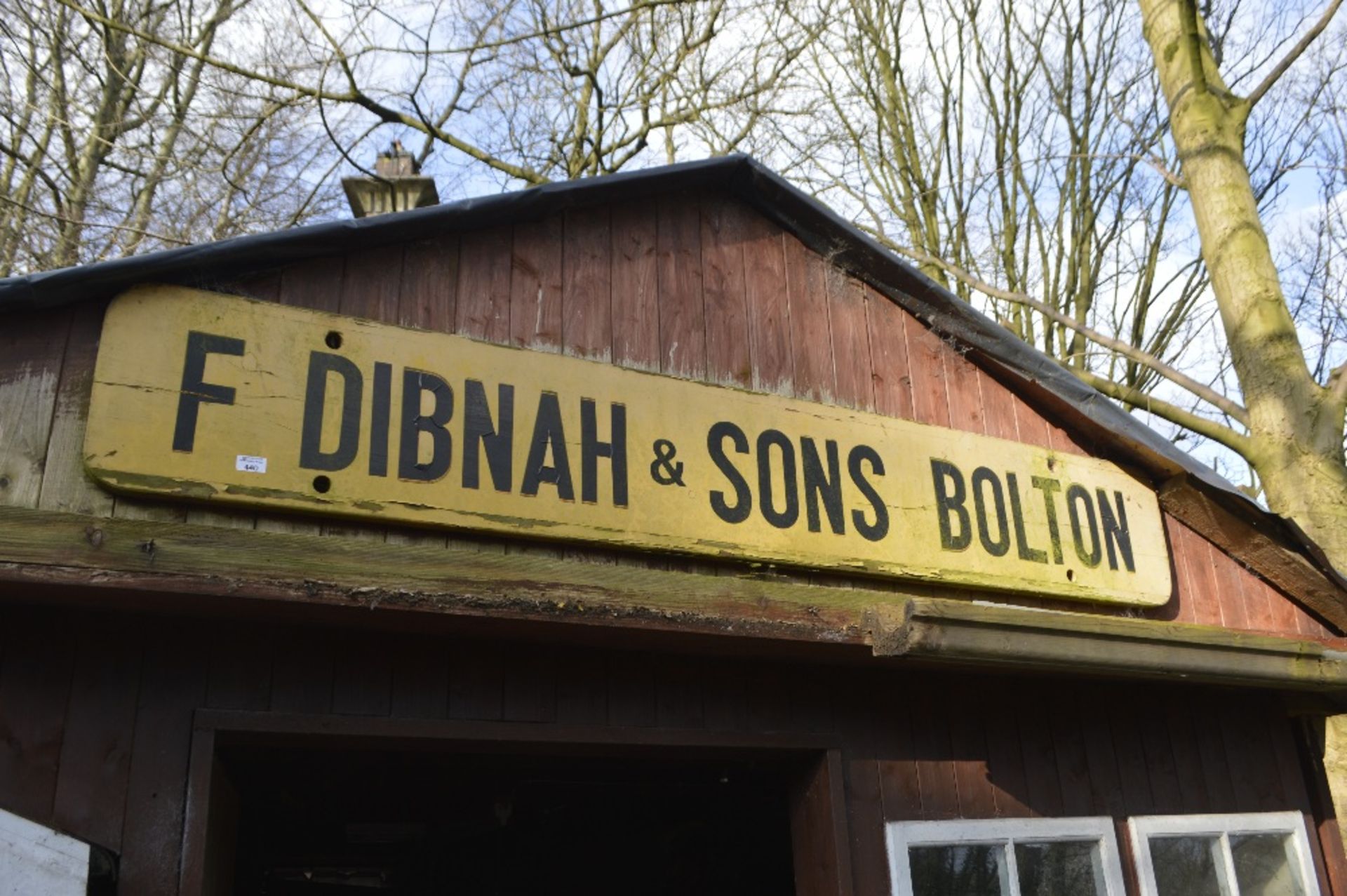 A wooden sign inscribed 'F Dibnah & Sons Bolton', width approx. 79".