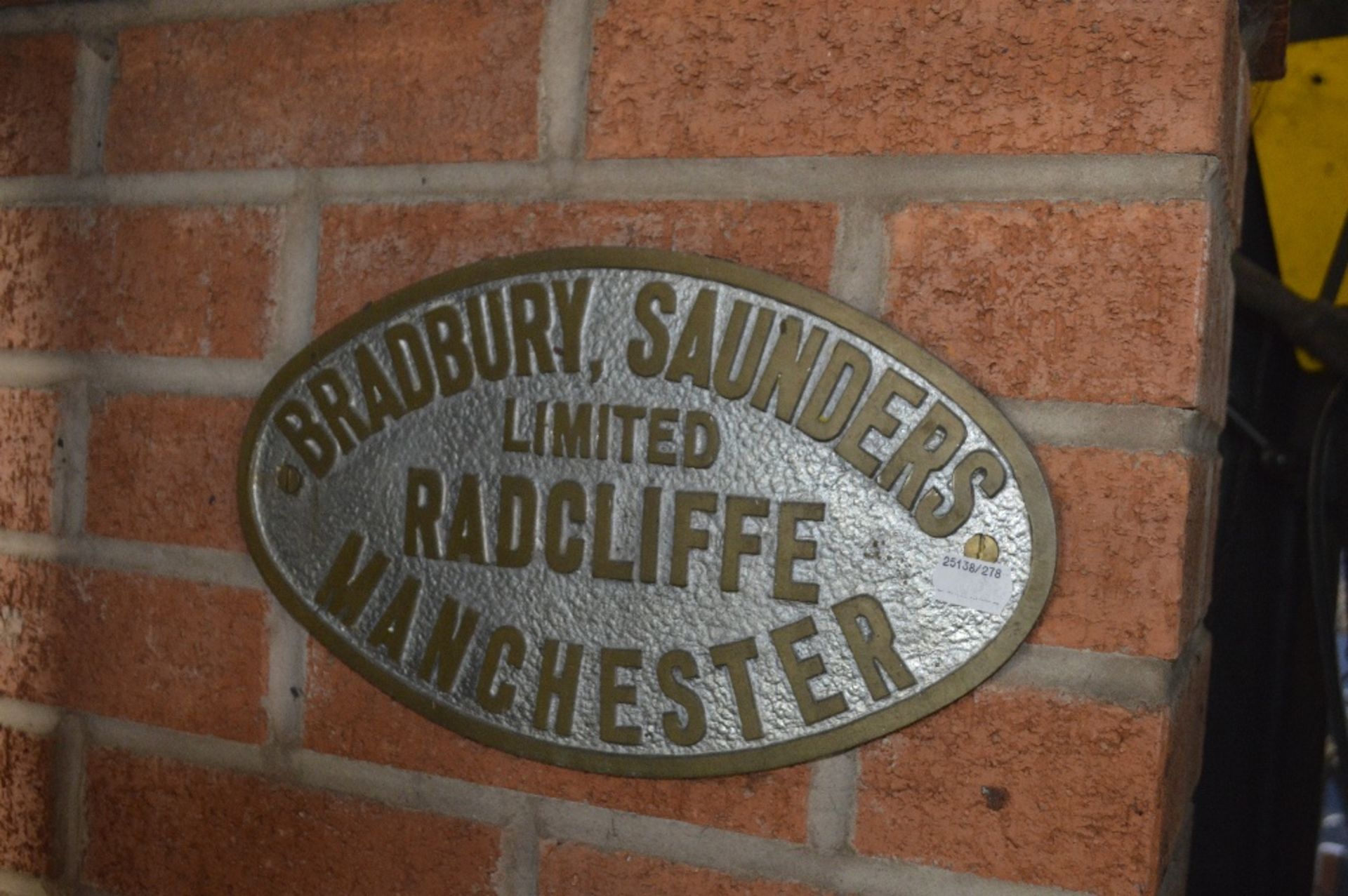 An oval plaque, inscribed 'Bradbury, Saunders Ltd. Radcliffe Manchester', width approx. 13".