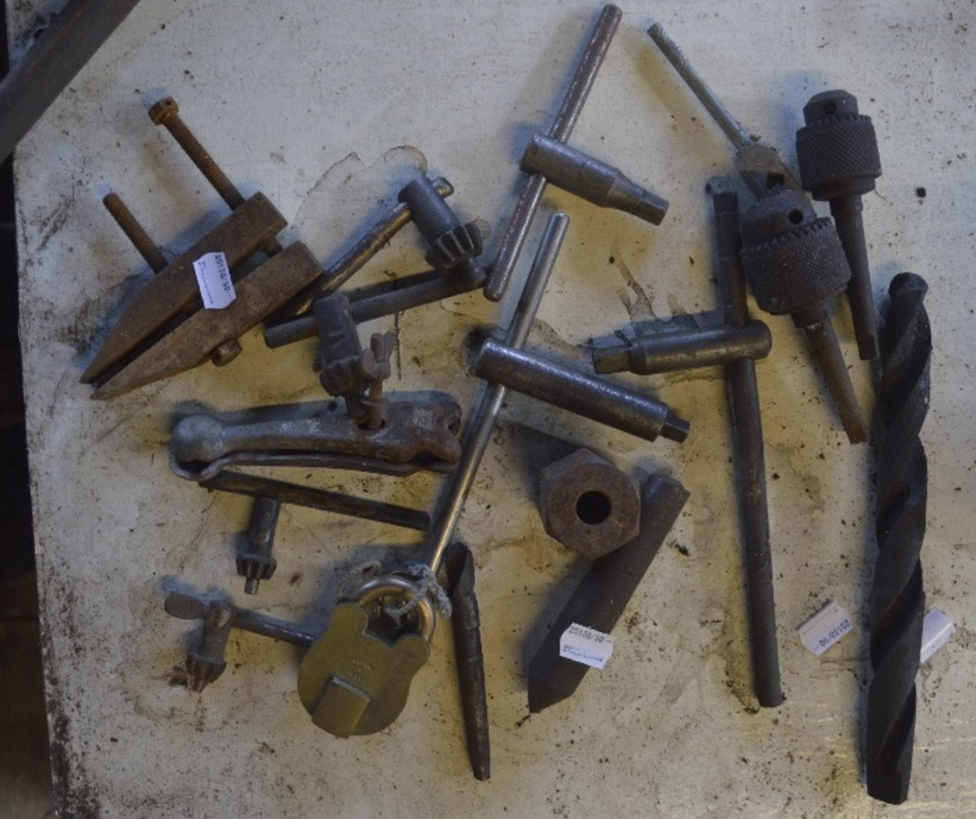 Miscellaneous items to include drill bits, T bars and a padlock.