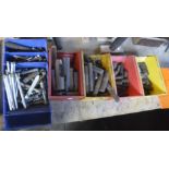 A large quantity of threaded studs and miscellaneous drill accessories.