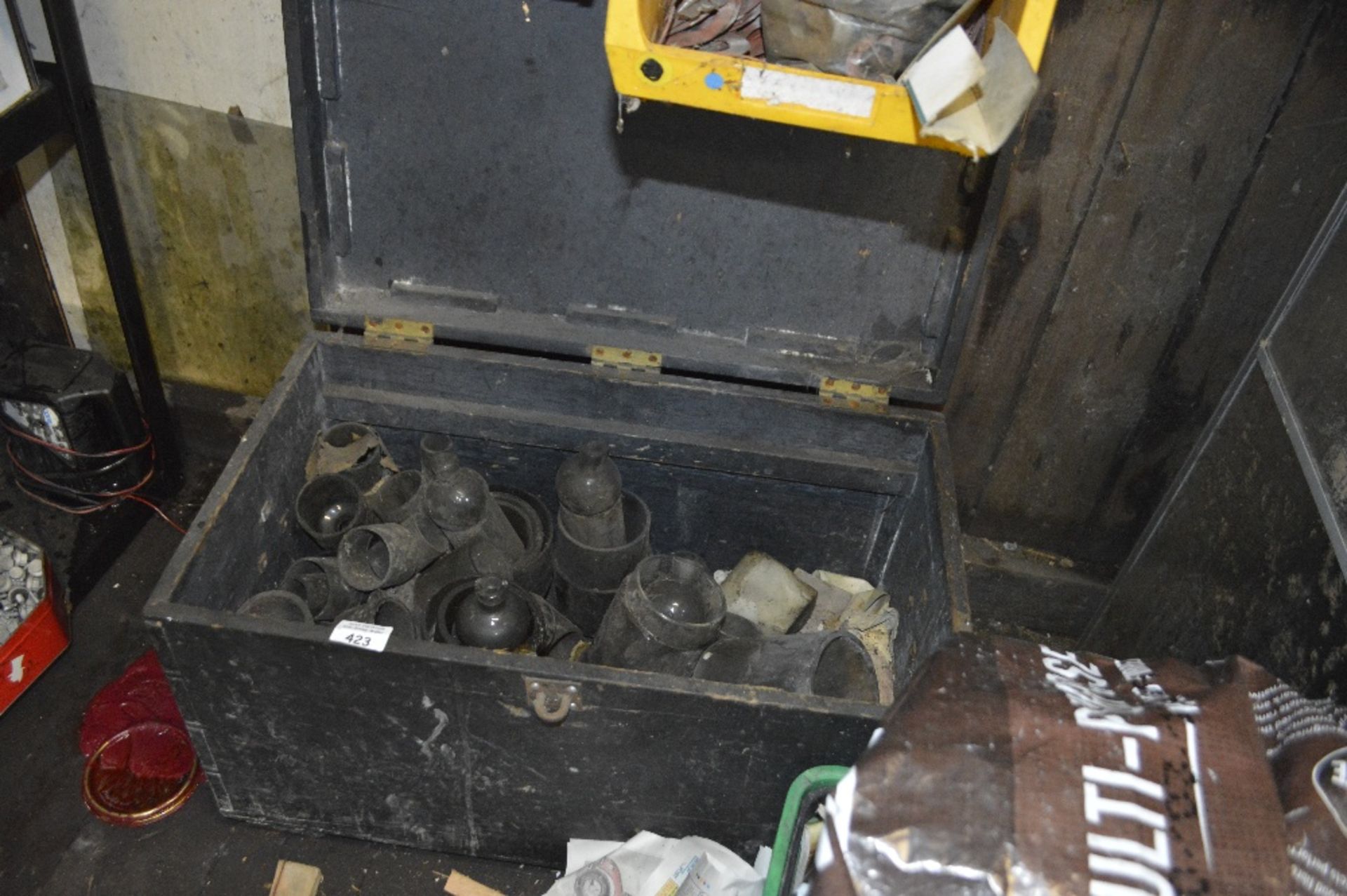 A wooden chest containing various glassware.