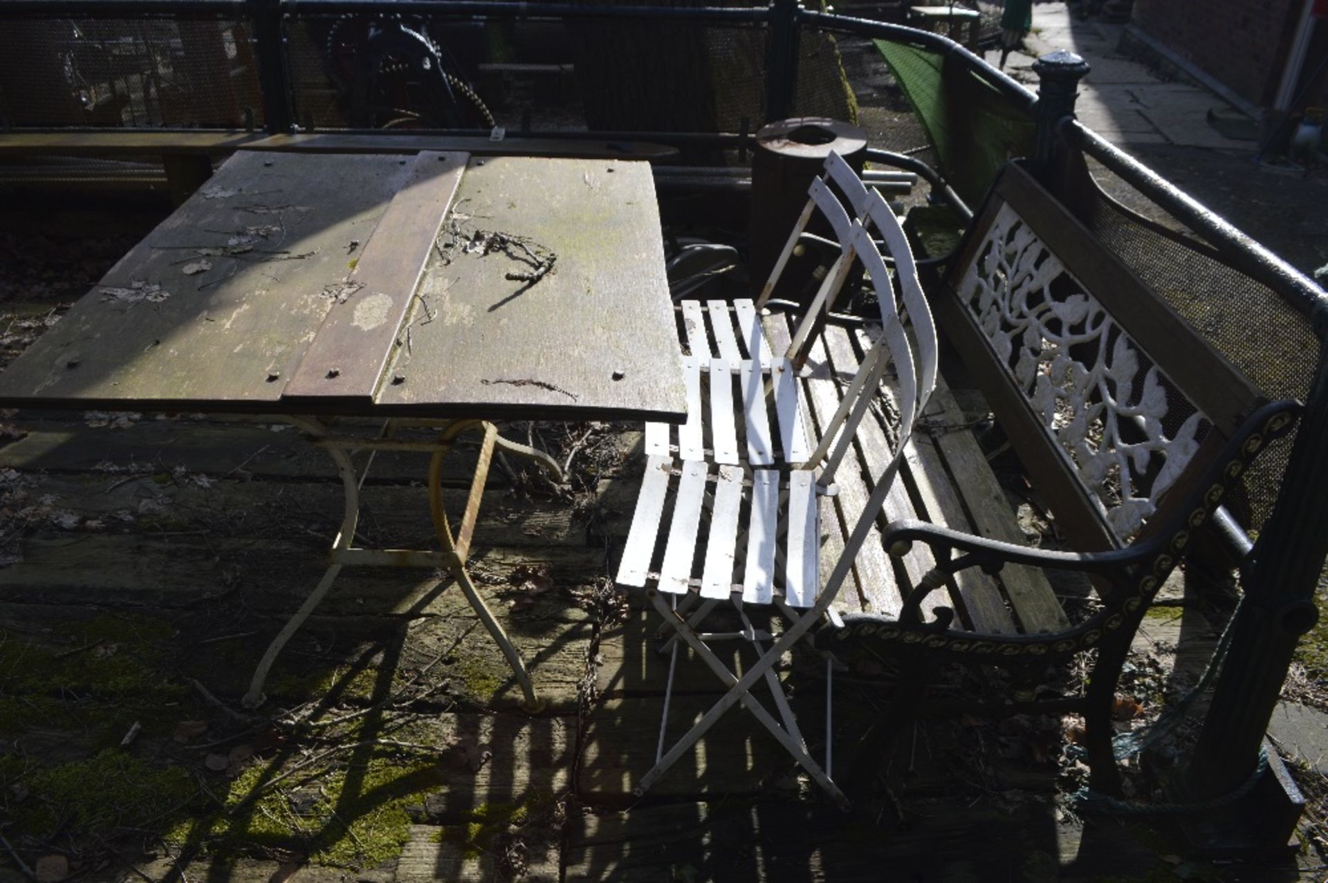 A garden table and three chairs, and a cast iron ended garden bench (5).