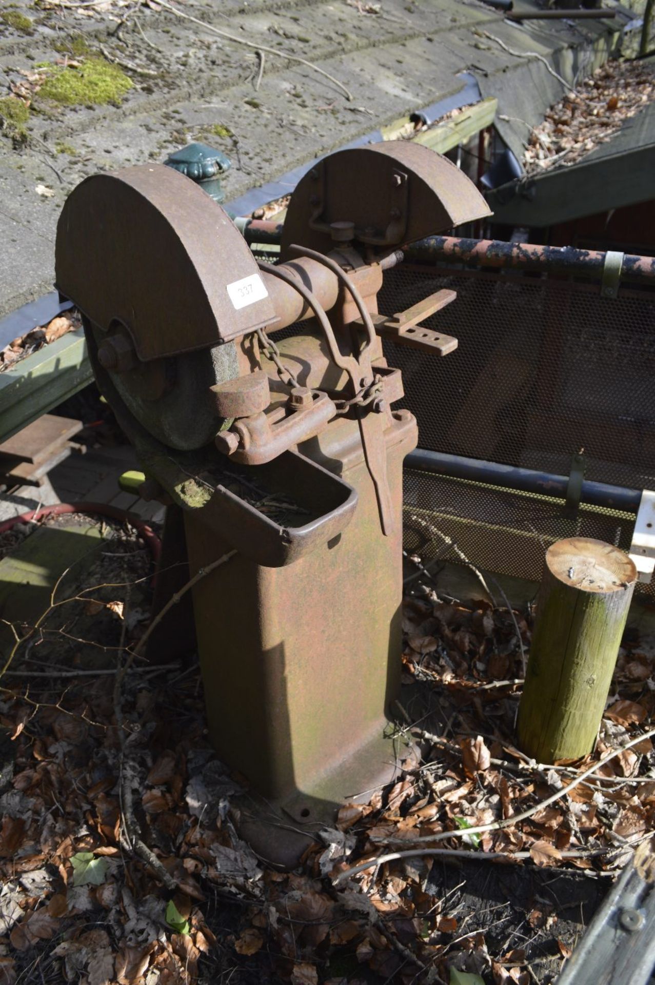 A twin-wheel grinder, height approx. 44".