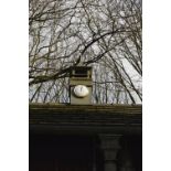 The clock tower from Fred Dibnah's workshop, the white circular dial set with Roman numerals.