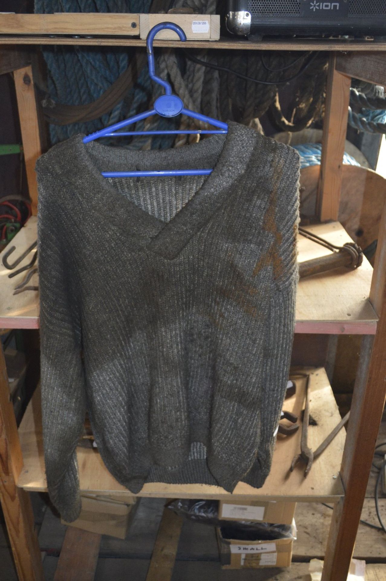 WITHDRAWN A grey wool V-neck sweater and two coats believed to have been owned and worn by Fred