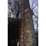 An iconic red painted wooden steeplejack ladder, with metal rung strengtheners and 21 rungs,