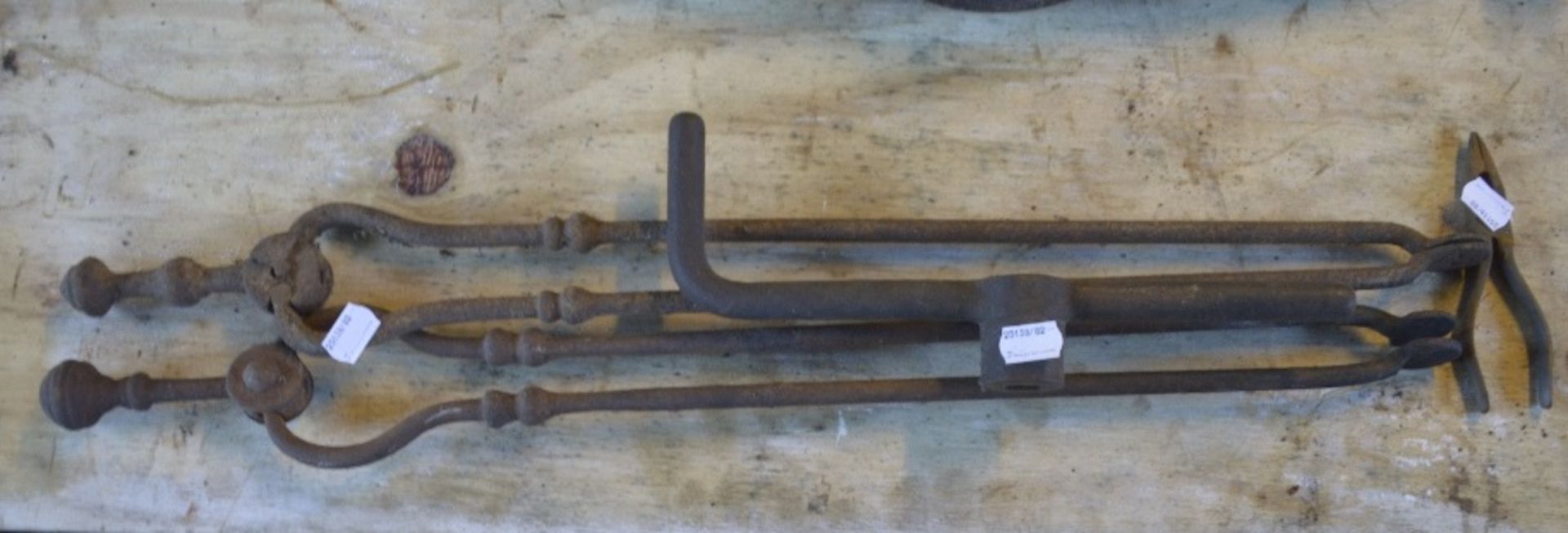 Two pairs of fire tongs, each length approx. 25", a winding handle and a pair of plyers (4).