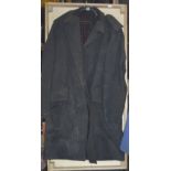 WITHDRAWN A black overcoat, believed to have been owned and worn by Fred Dibnah, in display case.