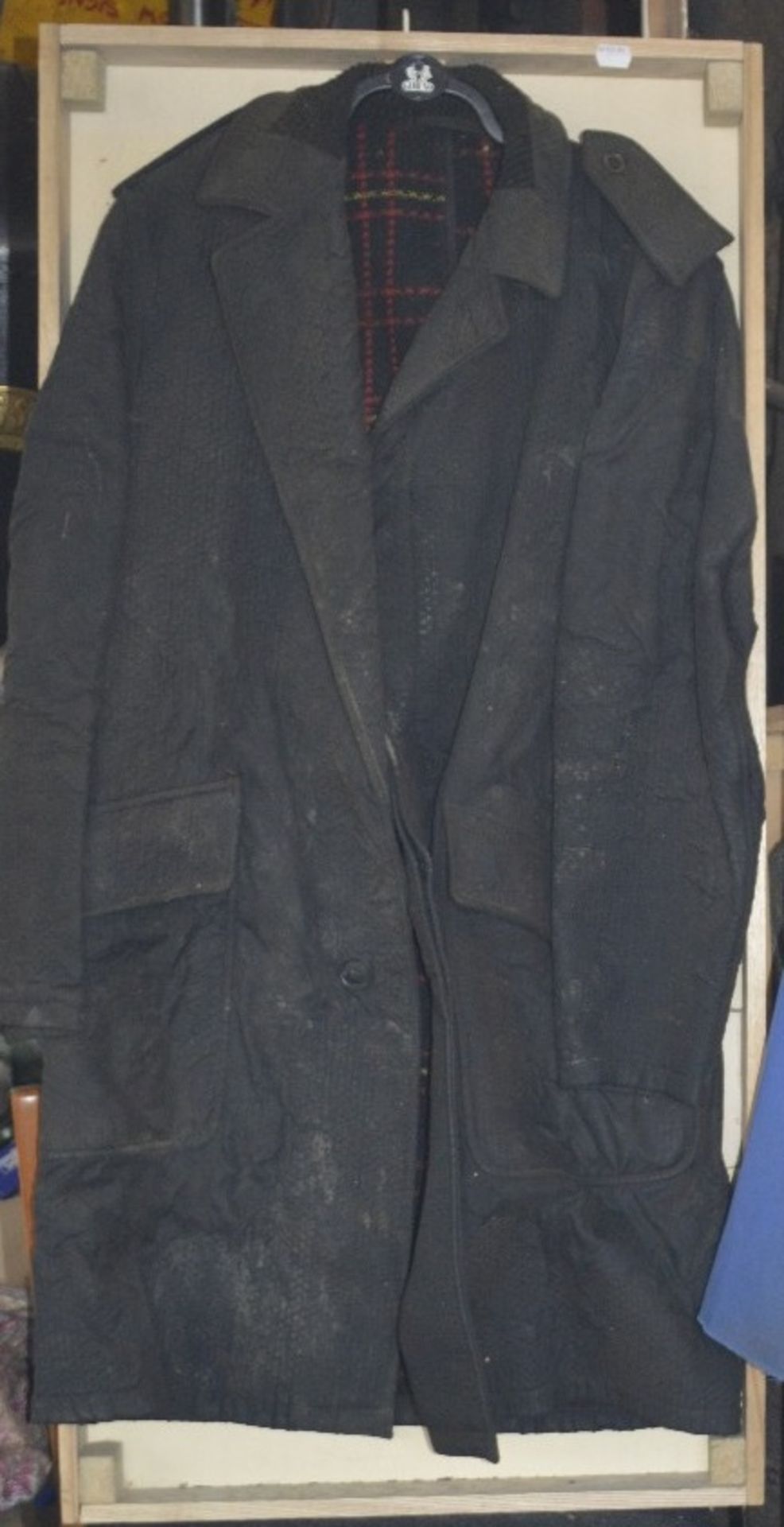 WITHDRAWN A black overcoat, believed to have been owned and worn by Fred Dibnah, in display case.