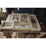 A collection of tools etc. in plywood mounts to include tongs, a pocket knife, a corkscrew (5).