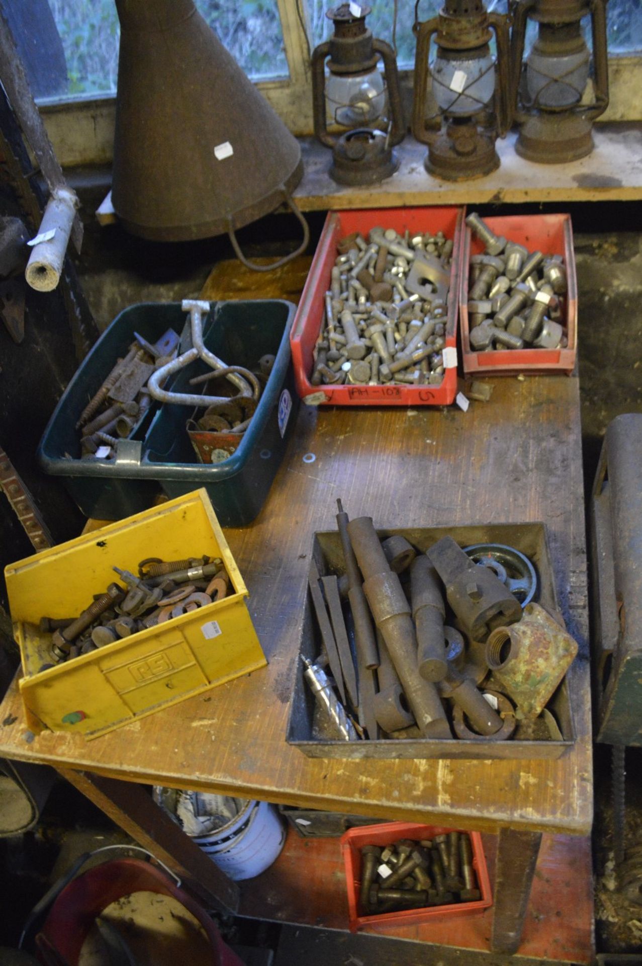 A quantity of boxes containing nuts, bolts, door handles etc.