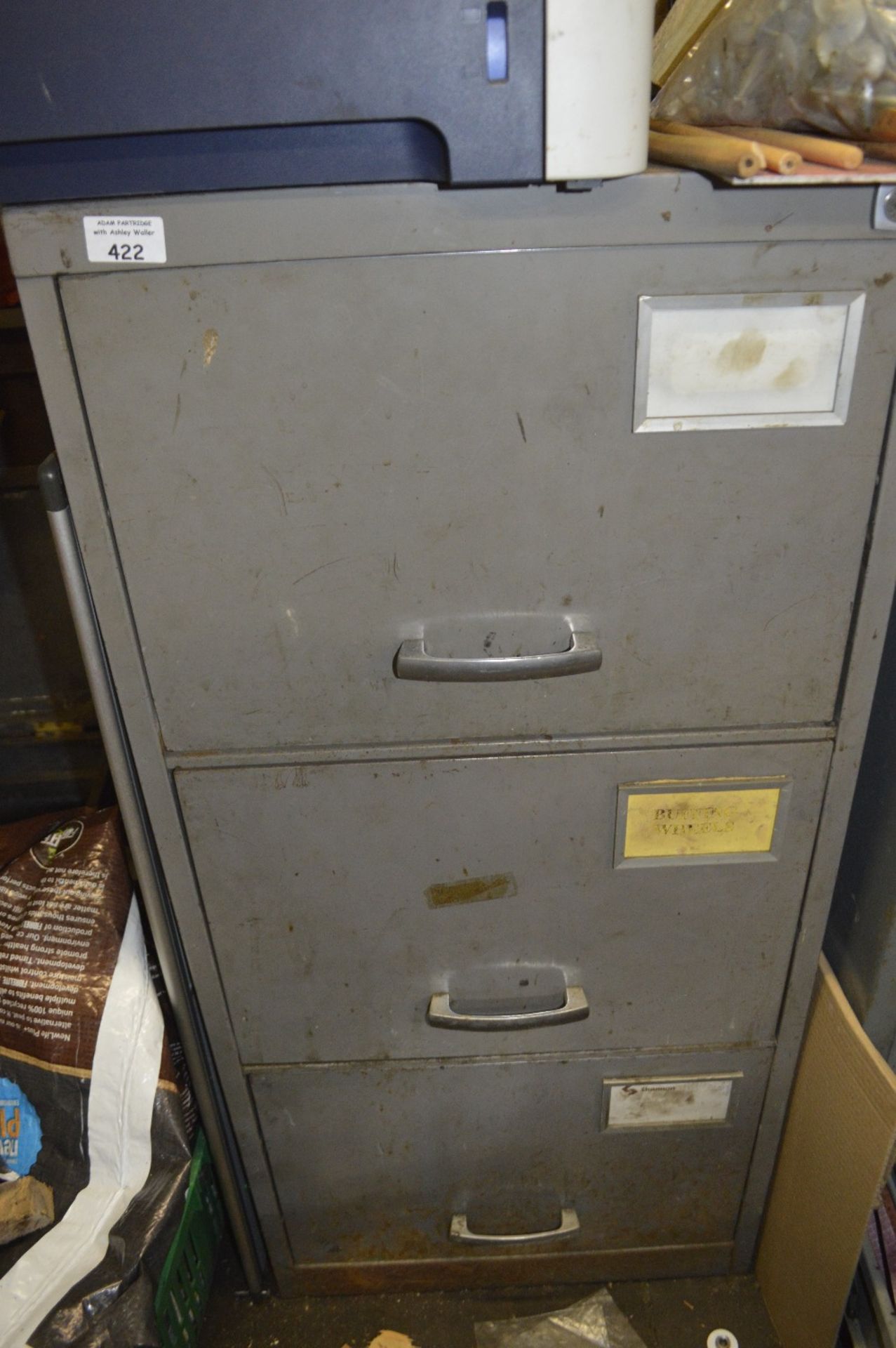 A three drawer filing cabinet and contents, to include sanding equipment.