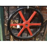 A red and black painted wheel, diameter approx. 18".