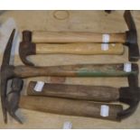 Four wooden handled hammers, each approx. 10", and a pick axe (5).