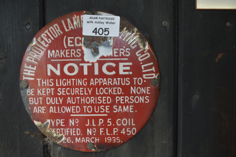 An enamel wall plaque, inscribed 'The Protector Lam... Co Ltd (ec...) Makers...er's notice.