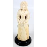 A 19th century French ivory figural triptych, the large female figure wearing bonnet and ermine