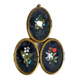 A 19th century Italian pietra dura floral decorated gilt metal mounted triple photograph frame, each