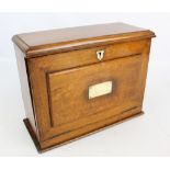 A Victorian oak writing box with leather inset fall front slope and hinged lid enclosing two