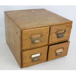 A set of four oak filing drawers, width 40cm.