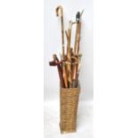 A collection of walking sticks and shepherd's crooks including a crook decorated with a thistle,