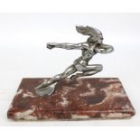 A 1920s chrome car mascot modelled as a running Native American, on rectangular pink marble base, 21