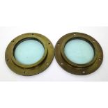 A pair of brass portholes retaining their original glass, diameter of each 24.5cm (2).