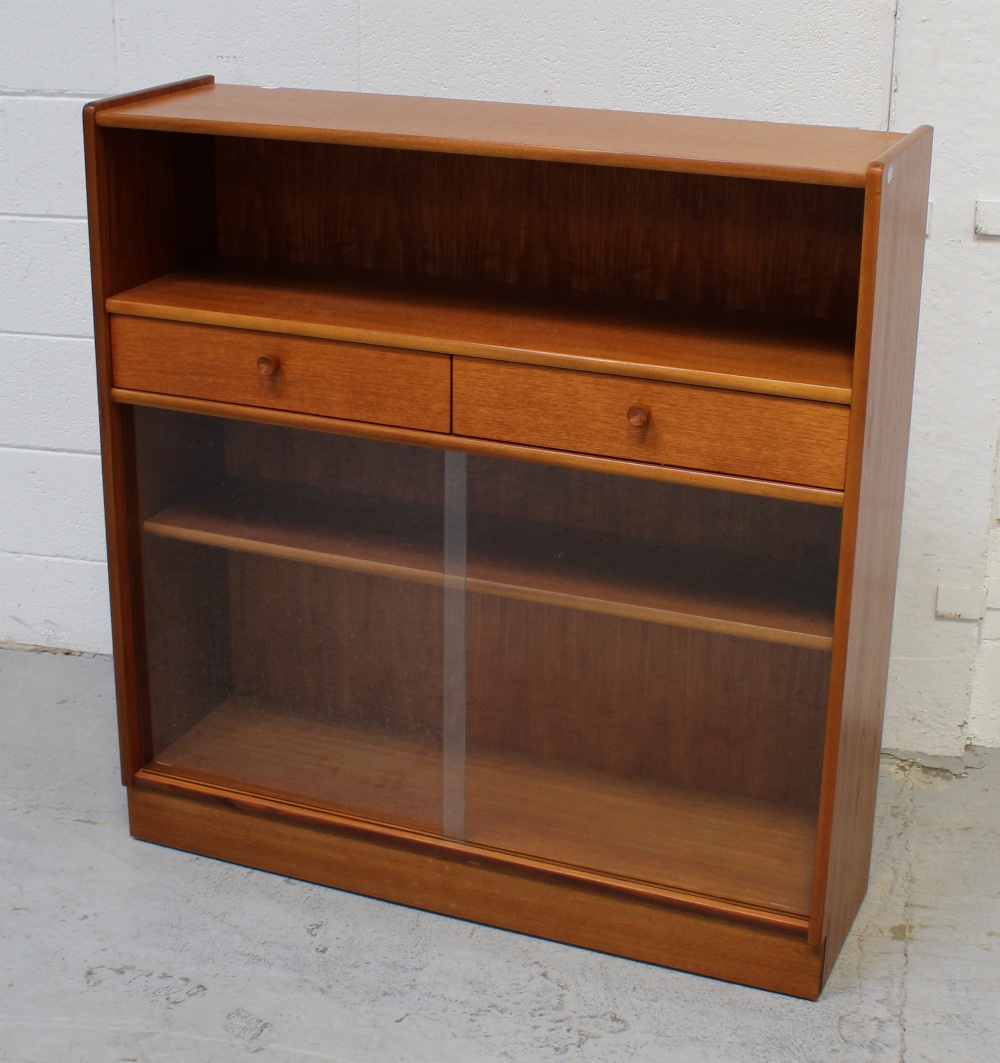 A retro-style bookcase with single shelf above two short drawers,