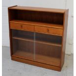 A retro-style bookcase with single shelf above two short drawers,