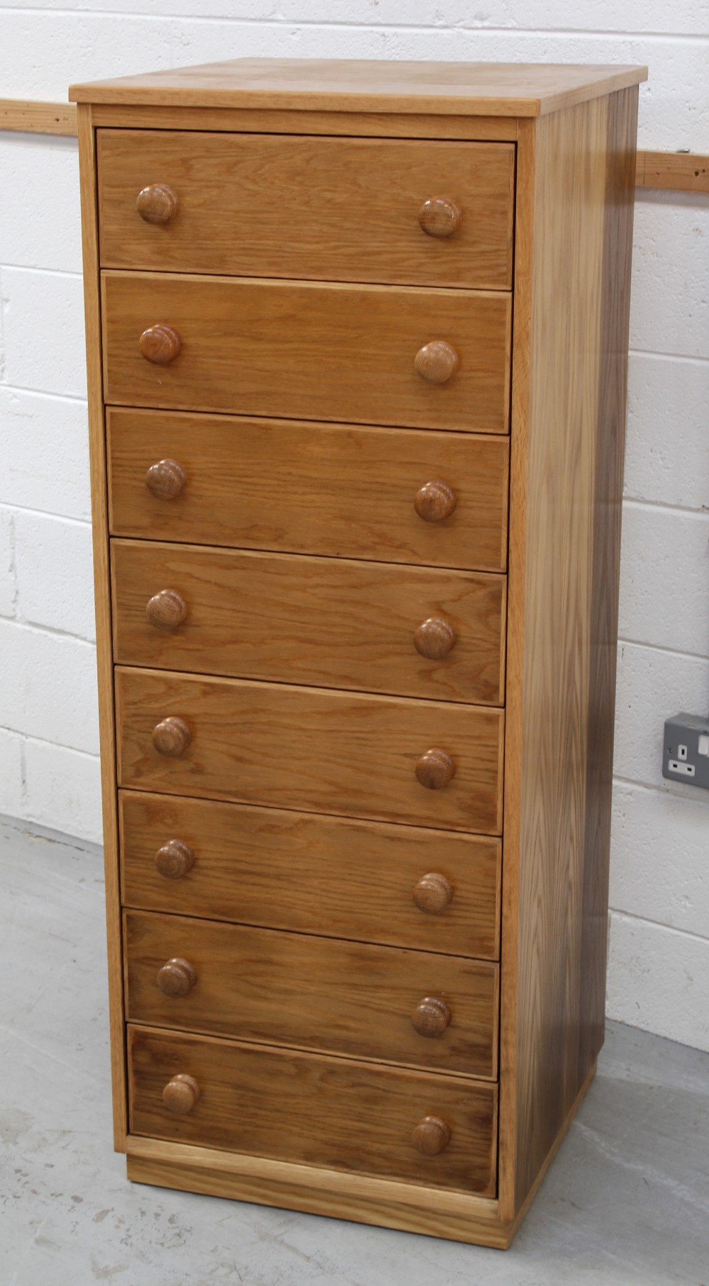 A modern pale oak chest of eight drawers, 135 x 53cm.