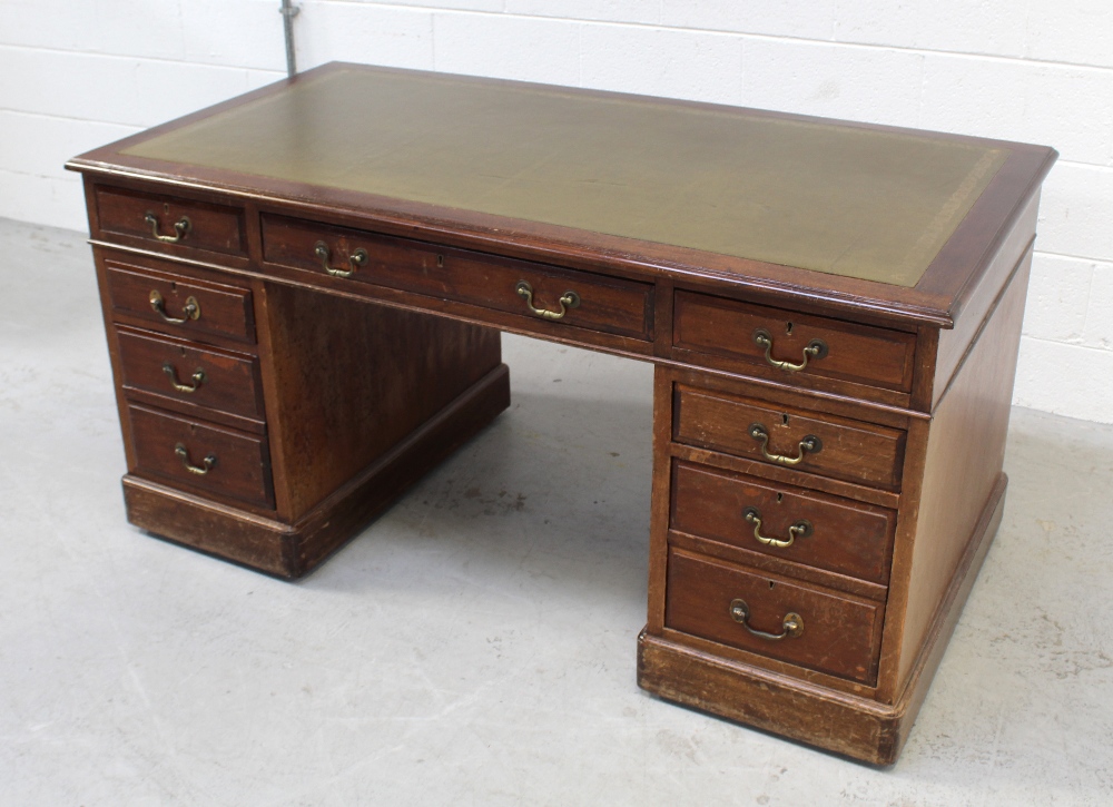 A Victorian mahogany twin-pedestal desk with inset gilt-tooled green leather top above central