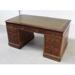 A Victorian mahogany twin-pedestal desk with inset gilt-tooled green leather top above central