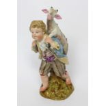 A 19th century Meissen figure group, boy in 18th century dress carrying a kid goat on his back,