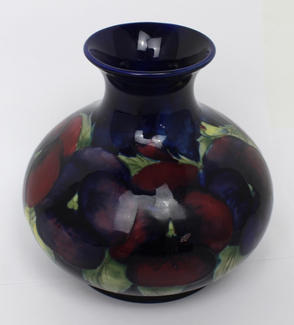 A Moorcroft cobalt blue ground squat baluster vase decorated in the 'Pansy' pattern,