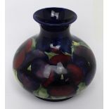 A Moorcroft cobalt blue ground squat baluster vase decorated in the 'Pansy' pattern,