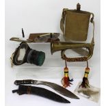 A small group of mixed military equipment, comprising a Royal Artillery bugle,