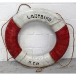 A life ring with painted marks 'Ladybird R.Y.A' with rope around outer rim, diameter approx 78cm.