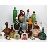 A quantity of decorative ceramic whisky decanters to include one with stopper modelled as a skull,