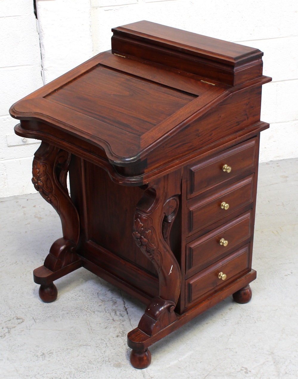 A modern reproduction tropical hardwood Davenport desk,