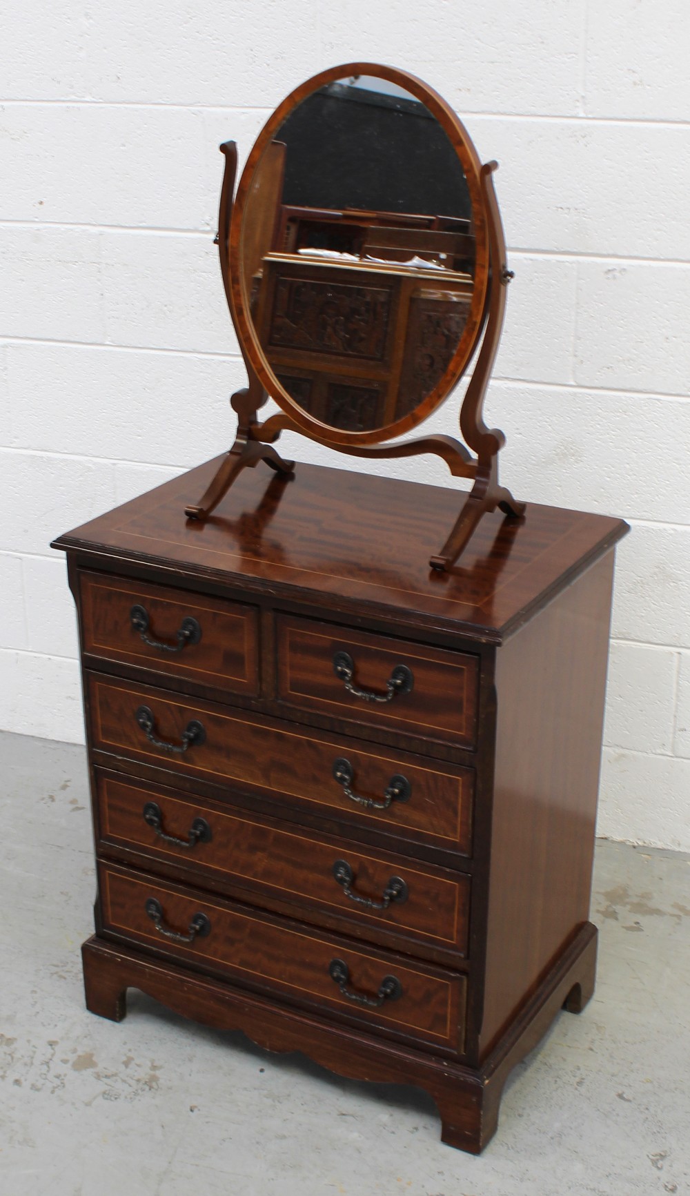 A reproduction mahogany chest of two short and three long drawers,