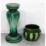 A green glazed jardinière with associated stand (stand af) (2).