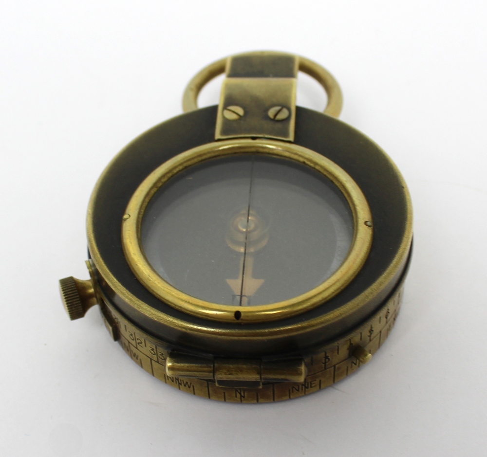 A military-issue compass, numbered 48000 and with broad arrow mark to reverse,