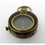 A military-issue compass, numbered 48000 and with broad arrow mark to reverse,
