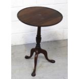 An early 20th century mahogany tilt-top occasional table on turned and wrythen tripartite column