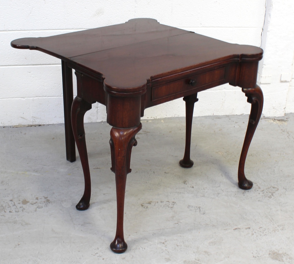 A mid-18th century mahogany two-leaf folding card and tea table with lobed corners,