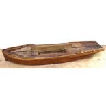 A scratch-built part-made wooden hull, made from strips of mahogany on a pine carcass, length 107cm.